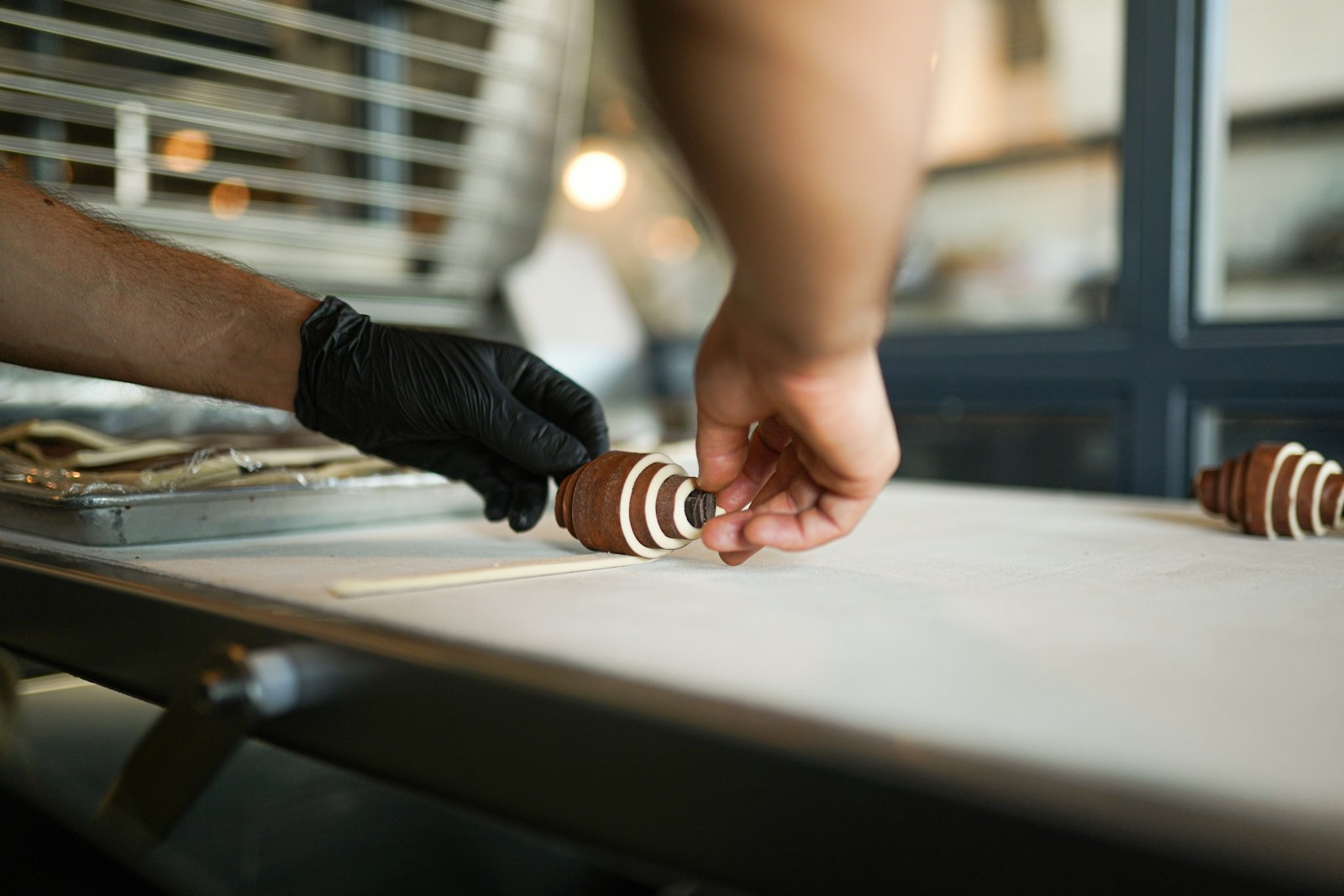 A person reaching for a piece of food on a table