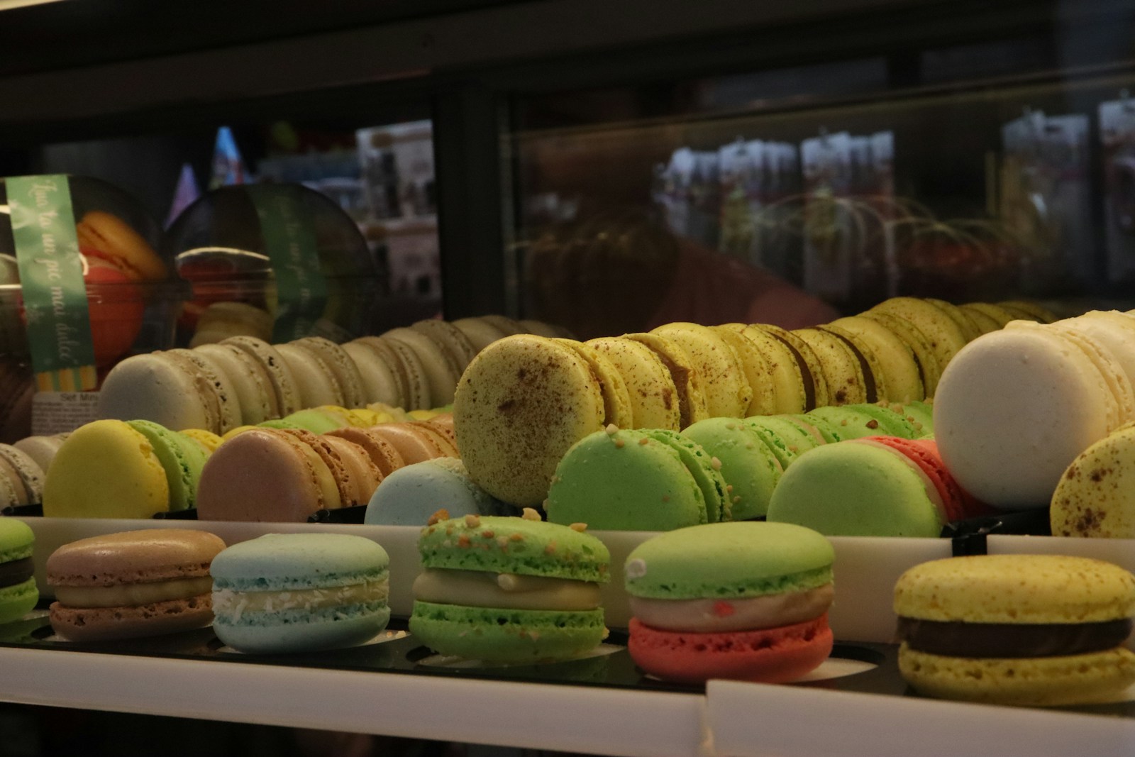 A display case filled with lots of different colored macaroons
